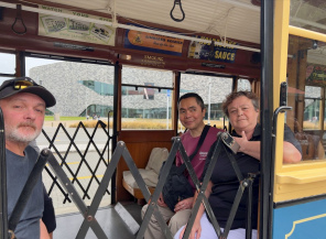 Ross, Julius and Chandra riding the Christchurch Tram which Kevin is driving