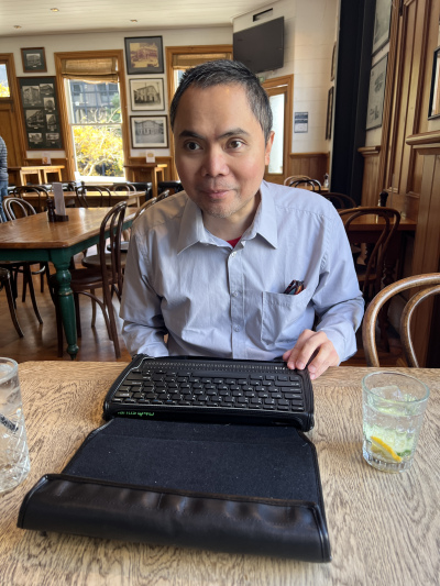 Julius demonstrating his Mantis dynamic Braille keyboard.