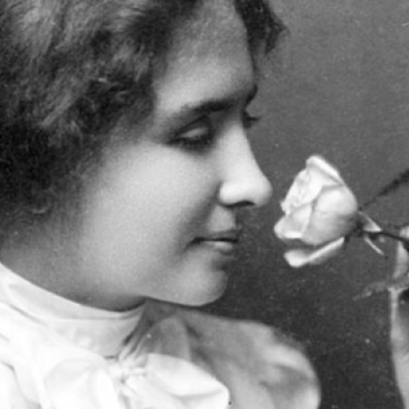 Helen Keller sniffing a rose
