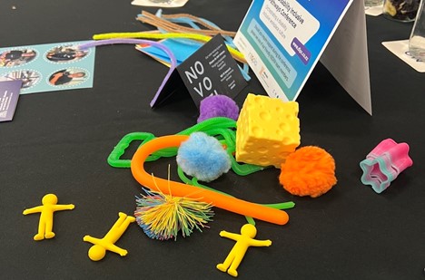 At conference able full of colourful fidget toys