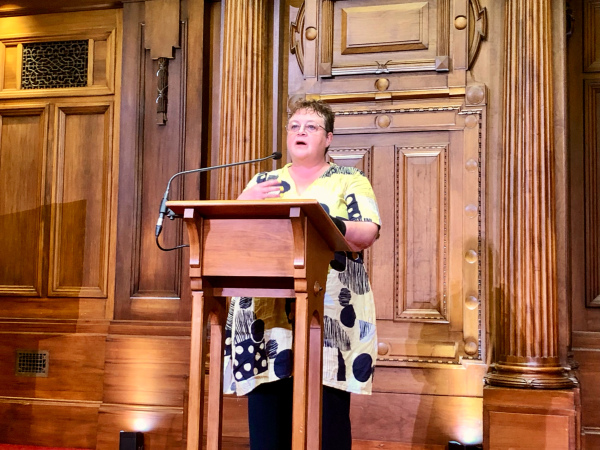 Chandra presenting from behnd the lecturn