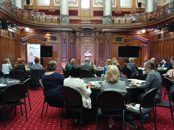 Chandra presenting to a room of MPs, business people and accessibility advocates