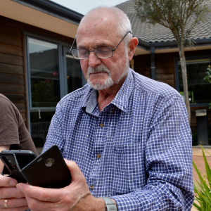 Arthur with his glasses checking on mobile