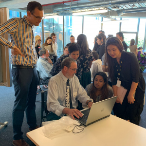 Chris demonstrating his screen reader to a group of people