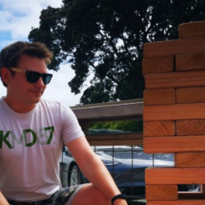 Eden outside playing jumbo jenga, wearing sunglasses