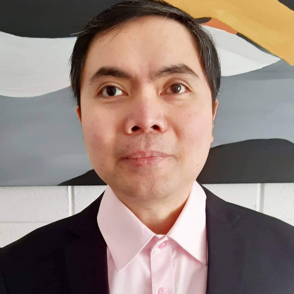 Julius looking confident and relaxed in a suit