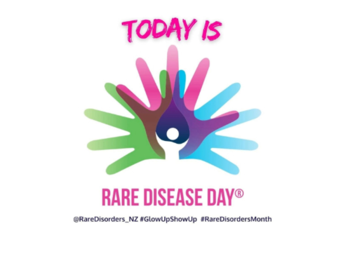 Green pink blue and purple overlapping handprints with with today is rare disease day text. A teardrop shape is in the centre of the hands and that has a person shape in it