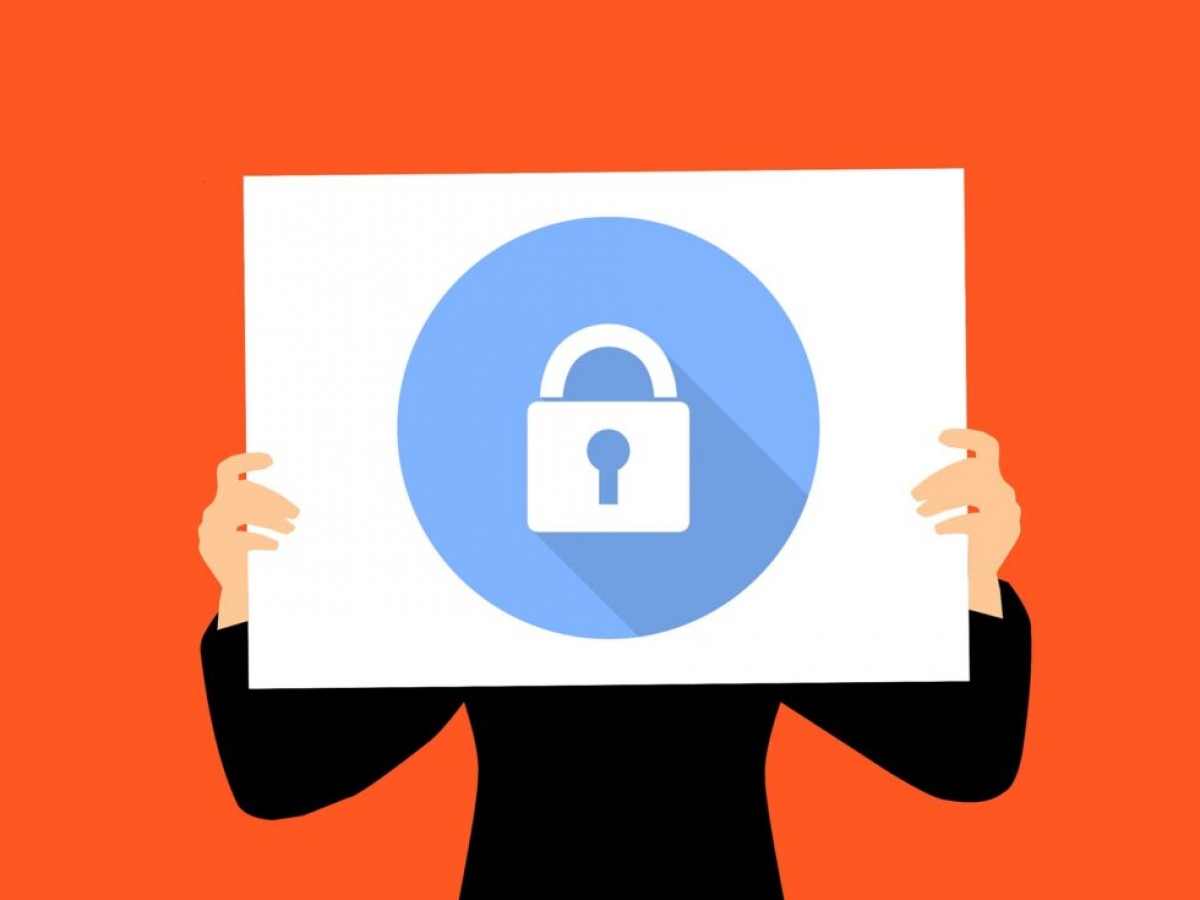 Sign with a locked icon held up blocking the view of a person's face